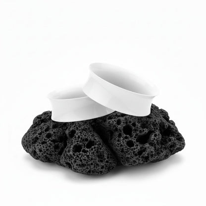 Pair of solid white silicone tunnels (plugs/gauges) for stretched ears. Flexible, lightweight alternative body jewelry.