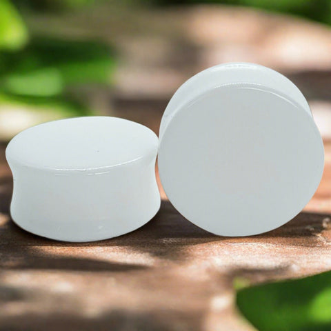a pair of white acrylic plugs for stretched ears
